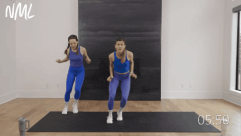 two women performing lateral squat jack walks as part of beginner cardio workout