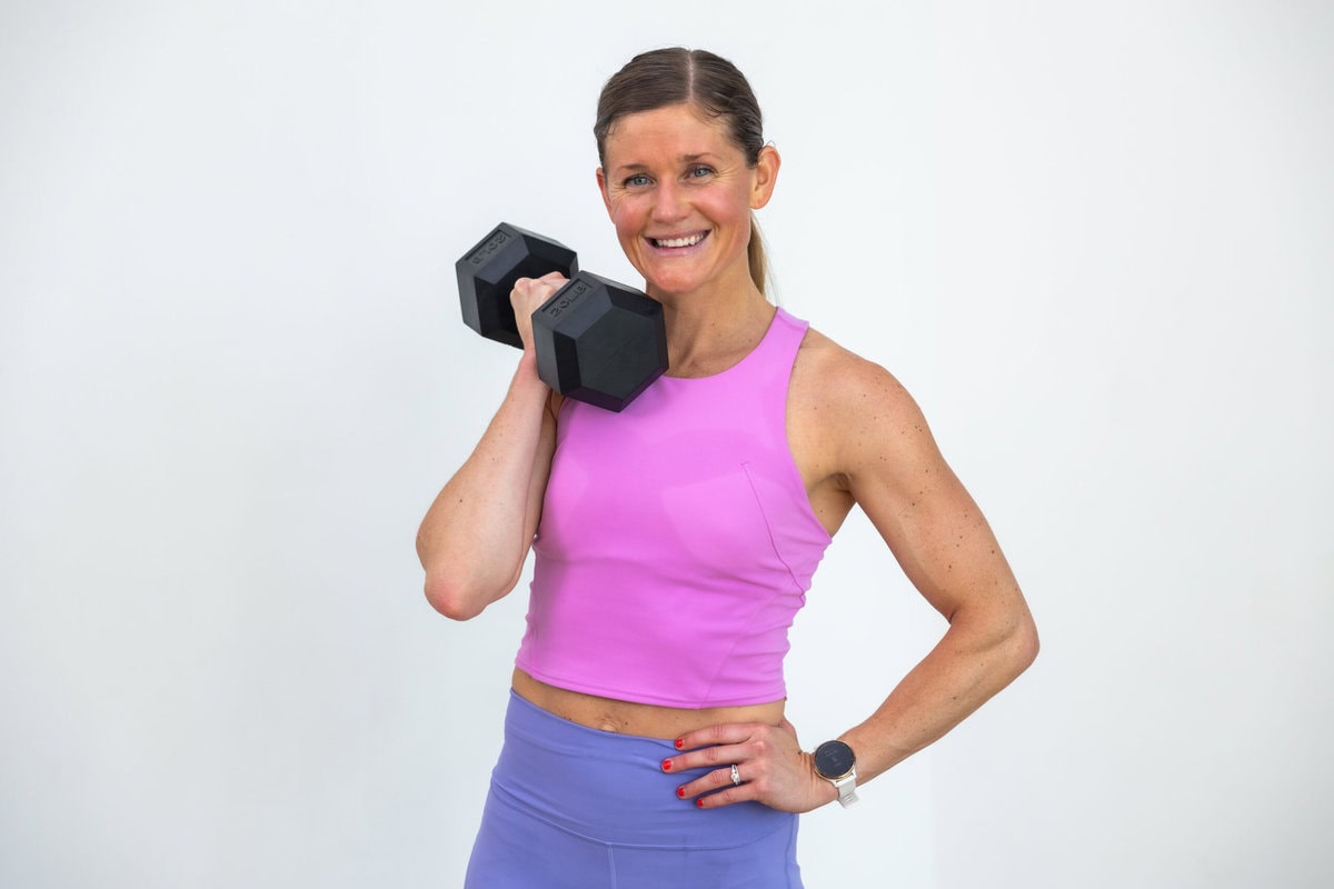 strong woman with toned arms holding a dumbbell ready to workout