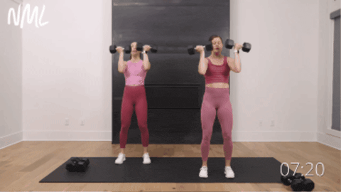 two women performing arnold presses as part of best upper body workout for women