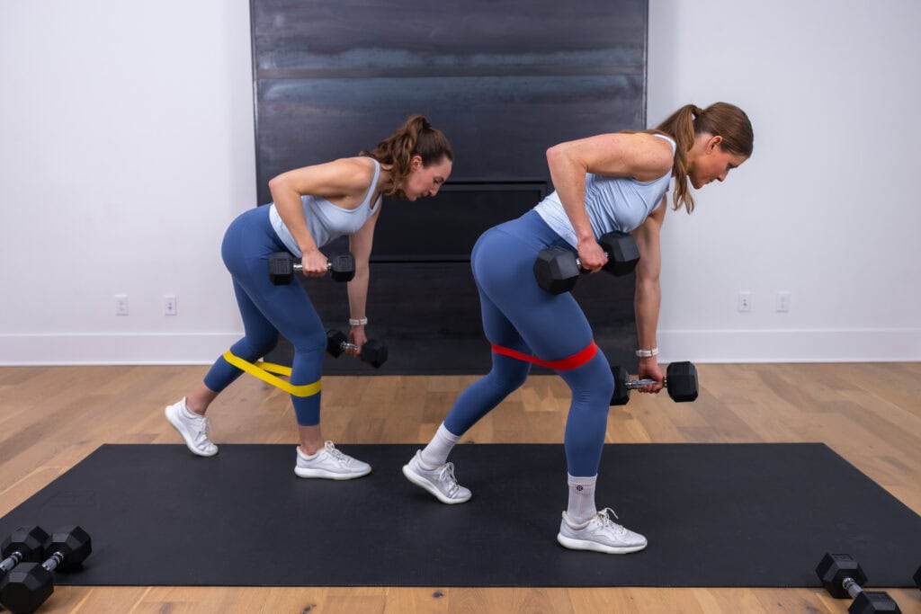 two women performing back row step back as example of LISS cardio exercises