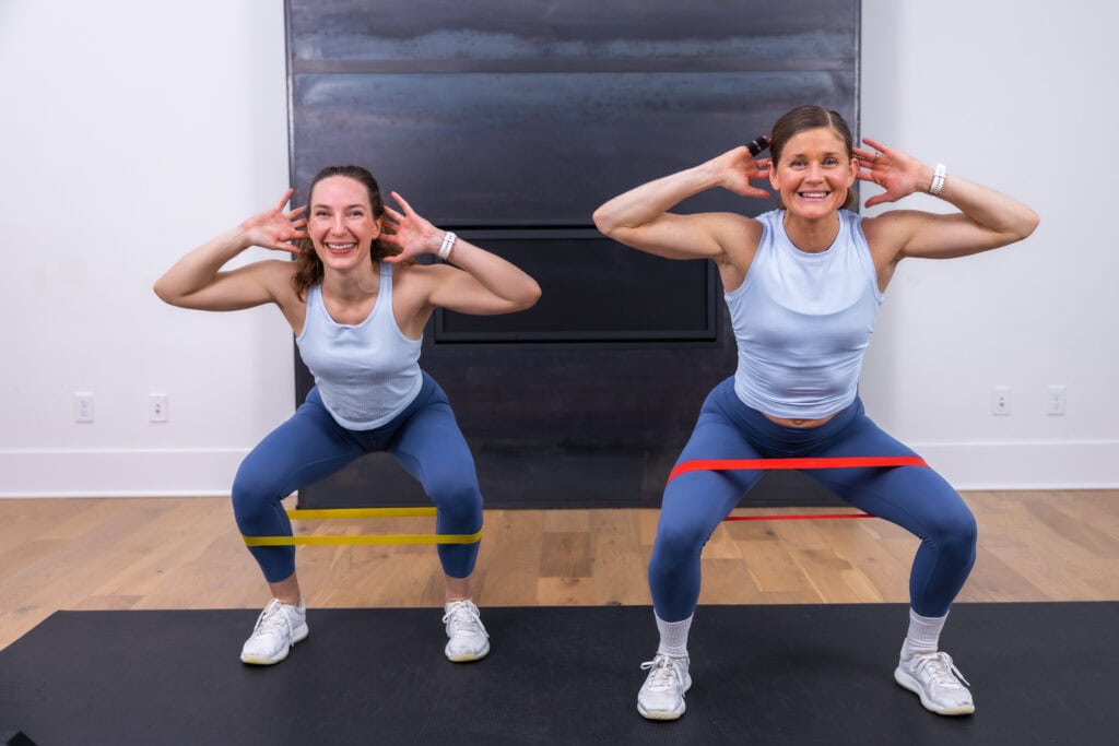 two women performing a low squat as example of LISS cardio exercise