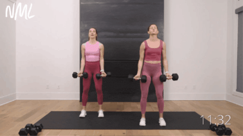 two women performing bicep curls as part of best upper body workout for women