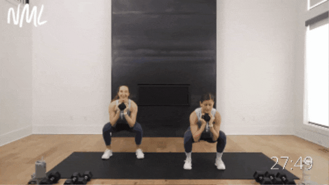 two women performing a squat and leg lift as example of liss cardio exercise