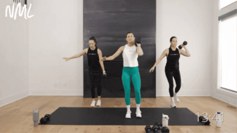 three women performing a dumbbell lateral lunge and reverse lunge as part of dumbbell only workout