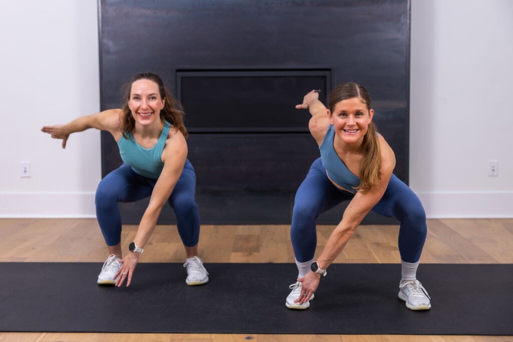 two women performing a low squat as part of low impact hiit workout