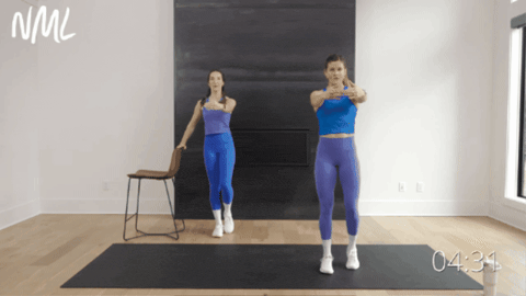 two women performing a balance knee drive and torso rotation as part of pilates ab workout
