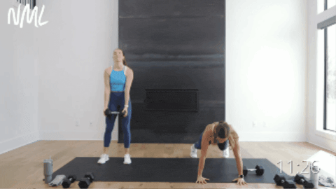 two women performing a dumbbell beast drag and push up as part of 30 minute workout at home