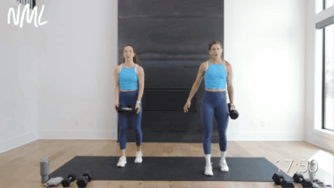 two women performing a reverse lunge with a single arm bicep curl