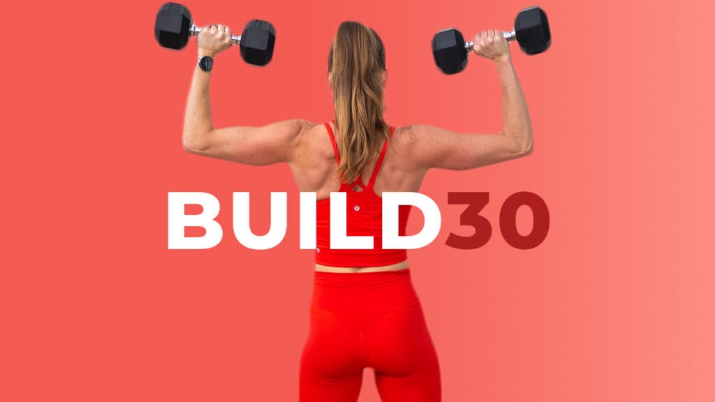 woman performing shoulder press as part of muscle building workout plan