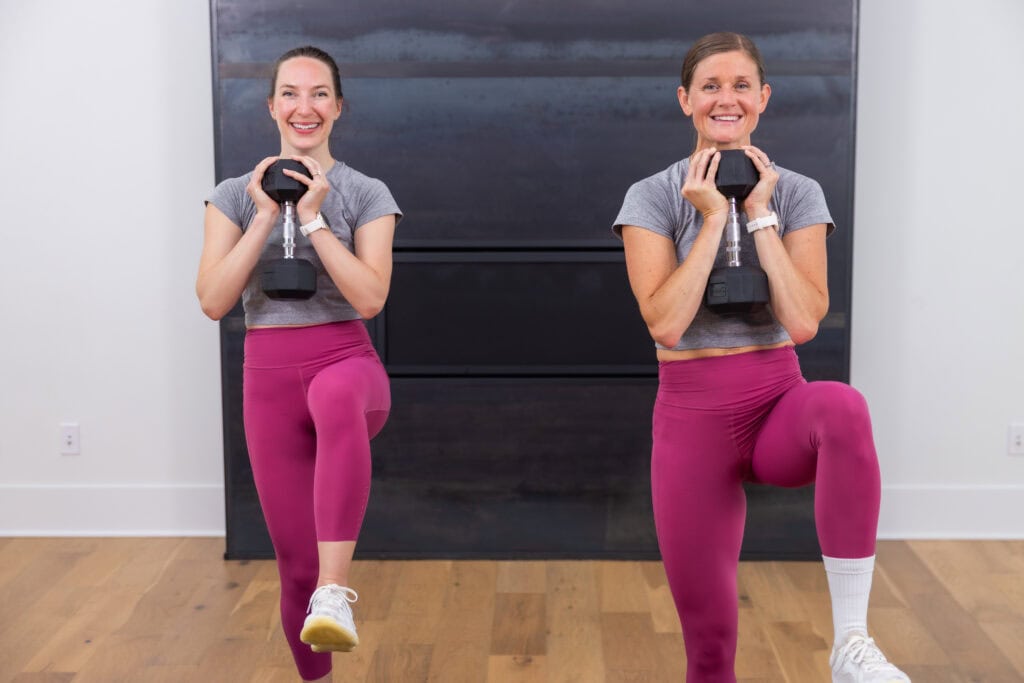 two women performing a goblet march with dumbbells to push heart rate into zone 2