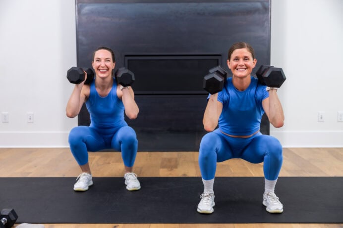 two women performing a front squat with dumbbells in a full body workout