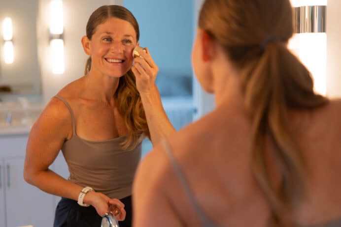 Women putting on Merit Beaut blush.