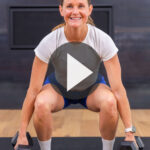 adult woman performing a dumbbell squat as part of at home full body workout