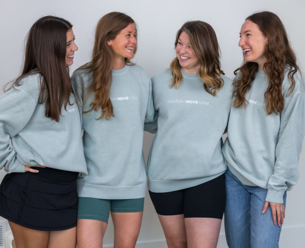 Team Nourish Move Love in sage green sweatshirts smiling 