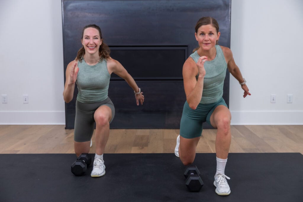 two women performing a reverse lunge as part of best leg day workout