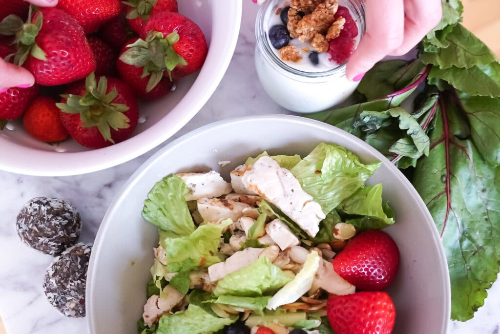 chicken salad with fresh strawberries and a yogurt parfait as part of a high protein diet